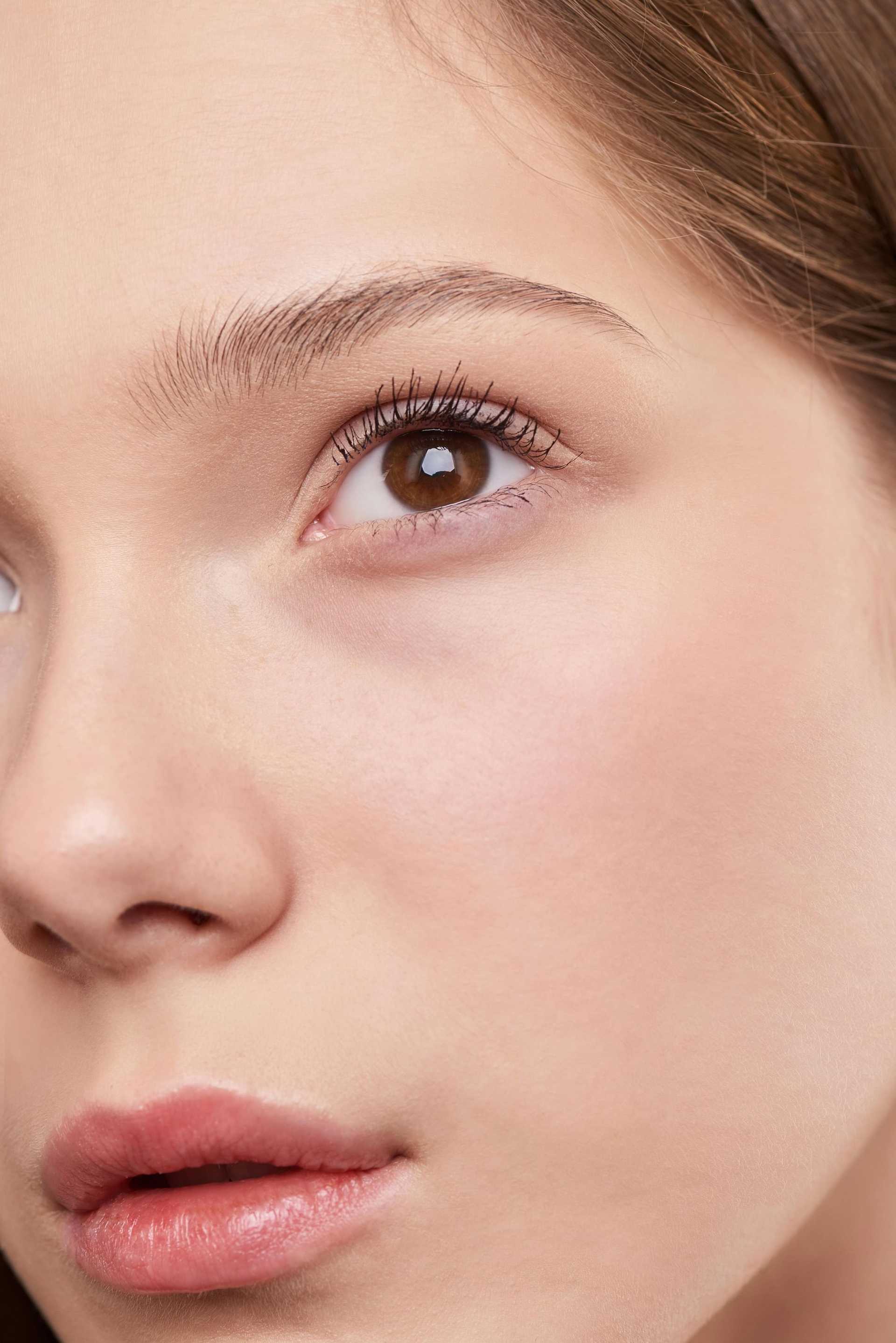 Close-up of a woman's eye and face, highlighting smooth skin and natural beauty.