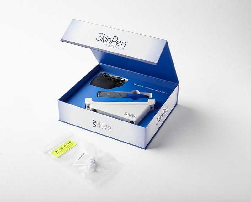 SkinPen Precision dermal device in open box, includes accessories and instruction manual.